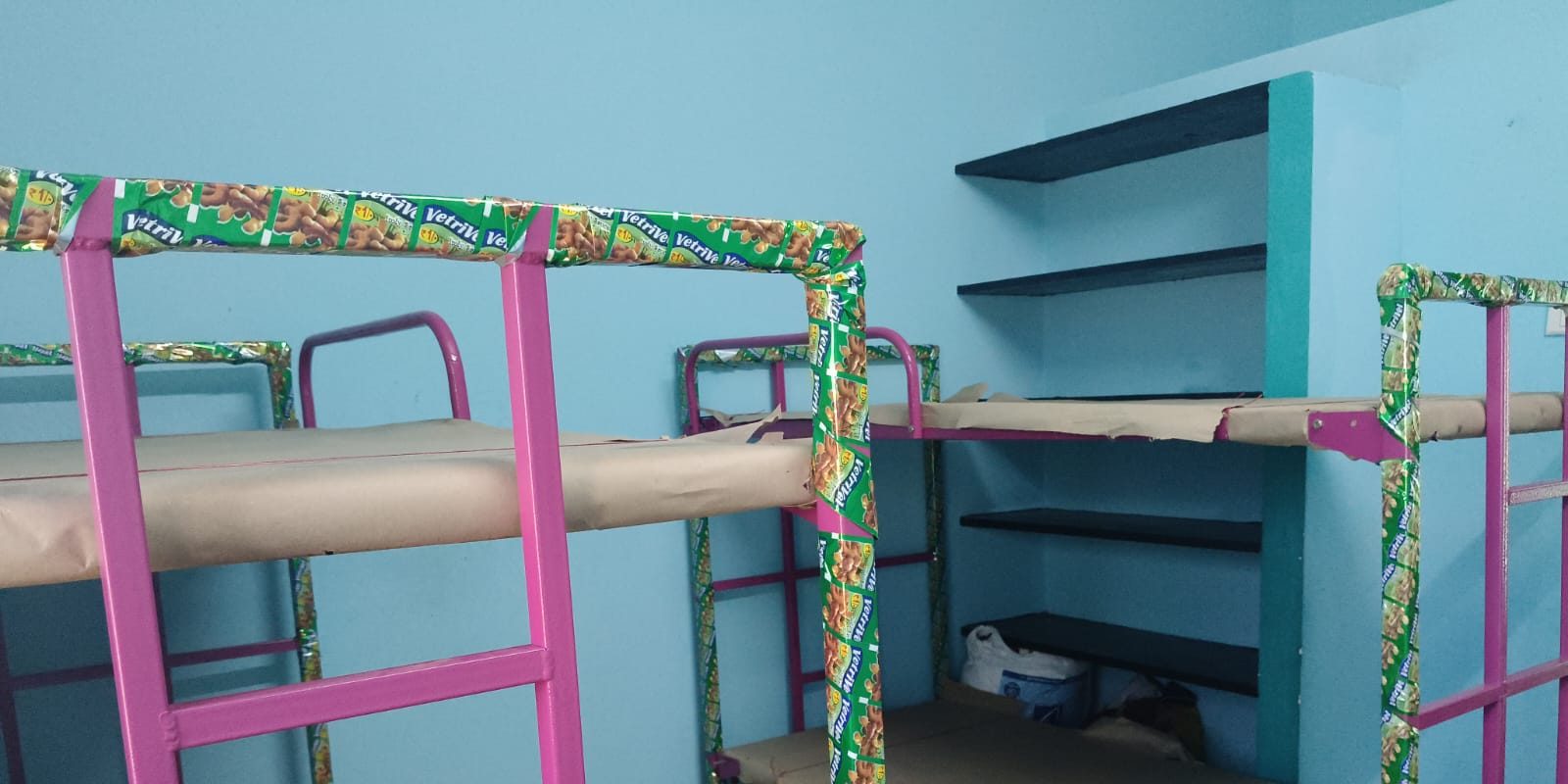 Hostel room with bunk beds and built-in shelving