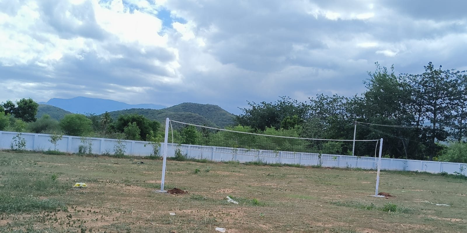 Volleyball court on the campus grounds with hills in the distance